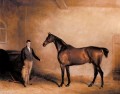 Sr. CN Hoggs Claxton y un novio en un establo de caballos John Ferneley Snr